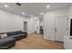 Bright living room featuring hardwood floors, recessed lighting, and a comfortable gray sofa at 3523 E Alfalfa Dr, Gilbert, AZ 85298