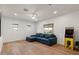 Spacious living room with a blue sectional couch and game machine at 3523 E Alfalfa Dr, Gilbert, AZ 85298