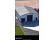 Exterior of a modern outbuilding that has white siding and dark trim, a garage door and a basketball hoop at 35809 N Evermore Madison St, San Tan Valley, AZ 85140