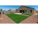 Expansive backyard featuring a patio, artificial turf, and desert landscaping, perfect for outdoor enjoyment at 38005 W Montserrat St, Maricopa, AZ 85138