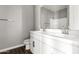 Bright bathroom featuring double sinks with modern fixtures and a large mirror at 38005 W Montserrat St, Maricopa, AZ 85138
