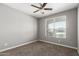 This bedroom features carpeted floors, neutral walls, and a ceiling fan, providing a cozy and comfortable atmosphere at 38005 W Montserrat St, Maricopa, AZ 85138