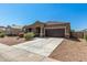 Inviting single-story home with desert landscaping, tile roof, and attached two-car garage at 38005 W Montserrat St, Maricopa, AZ 85138