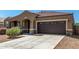 Charming home with covered entrance, two-car garage, and attractive stone accents at 38005 W Montserrat St, Maricopa, AZ 85138