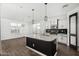 Bright kitchen features a large center island, modern lighting, and updated appliances at 38005 W Montserrat St, Maricopa, AZ 85138