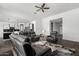 Spacious living area with modern furnishings, hardwood floors, and open flow to kitchen at 38005 W Montserrat St, Maricopa, AZ 85138