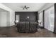 Cozy living room featuring leather recliners, hardwood flooring, and a modern aesthetic at 38005 W Montserrat St, Maricopa, AZ 85138