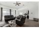 Open-concept living room featuring leather seating, wood floors, and natural light at 38005 W Montserrat St, Maricopa, AZ 85138