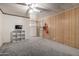 This is a large bedroom with a ceiling fan, wood paneled walls, and carpeted floors at 3807 W Abraham Ln, Glendale, AZ 85308