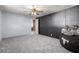 This is a spacious bedroom with black paneled accent wall, carpeted floor, and natural light at 3807 W Abraham Ln, Glendale, AZ 85308