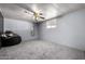This is a spacious bedroom with gray walls, carpeted floor, and natural light at 3807 W Abraham Ln, Glendale, AZ 85308