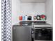 This laundry room features a Whirlpool washer and dryer, ample shelving, and modern fixtures at 3807 W Abraham Ln, Glendale, AZ 85308