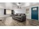 Inviting living room featuring a modern gray sofa, ample natural light, and attractive flooring at 3807 W Abraham Ln, Glendale, AZ 85308