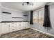 Living room showcasing white cabinets, floating shelves, and stylish vinyl plank flooring at 3807 W Abraham Ln, Glendale, AZ 85308
