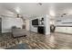 Spacious living room showcasing a large TV, modern furniture, and luxury vinyl plank flooring at 3807 W Abraham Ln, Glendale, AZ 85308