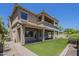 Expansive backyard featuring manicured landscaping, covered patio, and a spacious lawn at 3812 E Camelback Rd, Phoenix, AZ 85018