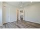 Bright, minimalist bedroom with wood-look floors, recessed lighting, and neutral paint at 3812 E Camelback Rd, Phoenix, AZ 85018