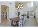 Bright dining room with seating for eight, modern lighting and open to game room at 3812 E Camelback Rd, Phoenix, AZ 85018