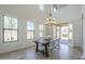 Spacious dining room with rustic table, modern lighting and view to outdoor patio at 3812 E Camelback Rd, Phoenix, AZ 85018