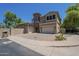 Charming two-story home featuring a stone tower, stucco exterior, and spacious driveway at 3812 E Camelback Rd, Phoenix, AZ 85018