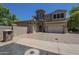 Charming two-story home featuring a stone tower, stucco exterior, and spacious driveway at 3812 E Camelback Rd, Phoenix, AZ 85018