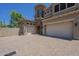Charming two-story home featuring a stone tower, stucco exterior, and spacious driveway at 3812 E Camelback Rd, Phoenix, AZ 85018