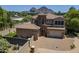 Stunning exterior of the home with a tile roof, stone accents, and a circular driveway at 3812 E Camelback Rd, Phoenix, AZ 85018