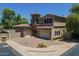Charming home featuring a tile roof, two-car garage, and well-manicured landscaping at 3812 E Camelback Rd, Phoenix, AZ 85018