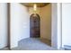 Elegant front entrance with a dark wood door and stucco surround at 3812 E Camelback Rd, Phoenix, AZ 85018