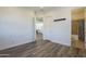 Hallway with wood-look floors leads to a bathroom, living room, and multiple doorways at 3812 E Camelback Rd, Phoenix, AZ 85018