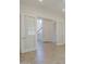 Bright hallway featuring light tile flooring, a stairway and paneled glass doors for an open feel at 3812 E Camelback Rd, Phoenix, AZ 85018