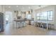 Updated kitchen showcasing stone countertops, island with seating, stainless appliances and tile floors at 3812 E Camelback Rd, Phoenix, AZ 85018