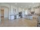 Well-appointed kitchen with seating for four, stainless appliances, tile floors and access to dining room at 3812 E Camelback Rd, Phoenix, AZ 85018