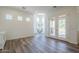 Bright living space with plenty of natural light, wood flooring, and decorative hanging chair at 3812 E Camelback Rd, Phoenix, AZ 85018