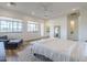 Spacious primary bedroom featuring wood-look floors, ample windows, and ensuite bathroom at 3812 E Camelback Rd, Phoenix, AZ 85018