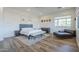 Bright and airy primary bedroom showcasing wood-look floors, decor, and furnishings at 3812 E Camelback Rd, Phoenix, AZ 85018