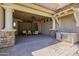 Covered patio with outdoor seating, fan, TV, lighting and built-in grill at 3812 E Camelback Rd, Phoenix, AZ 85018