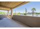 Spacious covered patio with open-air design, views of palm trees, local dwellings, and scenic mountain views at 3812 E Camelback Rd, Phoenix, AZ 85018