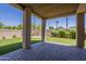 Covered patio area with stone pavers and a view of the landscaped backyard and palm trees at 3812 E Camelback Rd, Phoenix, AZ 85018