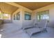Covered patio featuring neutral tones, outdoor lounge chairs and multiple framed windows for natural lighting at 3812 E Camelback Rd, Phoenix, AZ 85018
