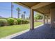 Covered patio overlooking a spacious lawn with desert landscaping and palm trees at 3812 E Camelback Rd, Phoenix, AZ 85018