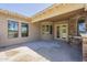 Covered patio area featuring stucco siding, stone details, and multiple windows offering serene outdoor views at 3812 E Camelback Rd, Phoenix, AZ 85018