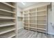 Large walk-in closet offers ample shelving, hanging rods, and modern wood-look floors at 3812 E Camelback Rd, Phoenix, AZ 85018