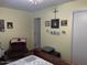 Bedroom with an armchair and Ottoman, with several Gathering photos on the light yellow wall at 40047 N Cassara Dr, San Tan Valley, AZ 85140