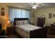 Comfortable bedroom with a queen-size bed, ample natural light, and neutral decor at 40047 N Cassara Dr, San Tan Valley, AZ 85140