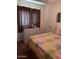 Bedroom view showcasing natural light, dresser, and comfy quilt on bed at 40047 N Cassara Dr, San Tan Valley, AZ 85140