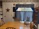 A charming dining area with a wooden table and patriotic-themed decor at 40047 N Cassara Dr, San Tan Valley, AZ 85140