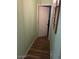 Hallway with wood-look flooring, mint-green walls, and framed pictures at 40047 N Cassara Dr, San Tan Valley, AZ 85140