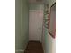 Hallway featuring white door and framed artwork on a light green wall at 40047 N Cassara Dr, San Tan Valley, AZ 85140