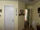 Hallway featuring a white door and a decorative collection of circular photo frames on a light yellow wall at 40047 N Cassara Dr, San Tan Valley, AZ 85140